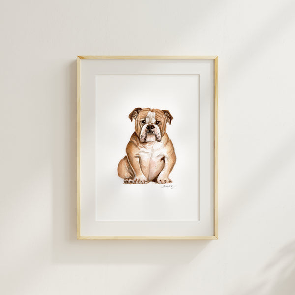 Watercolor painting of a tan bulldog in a light wood frame.