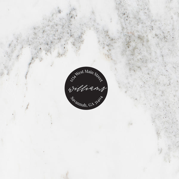 Circle address sticker in black with modern script font.