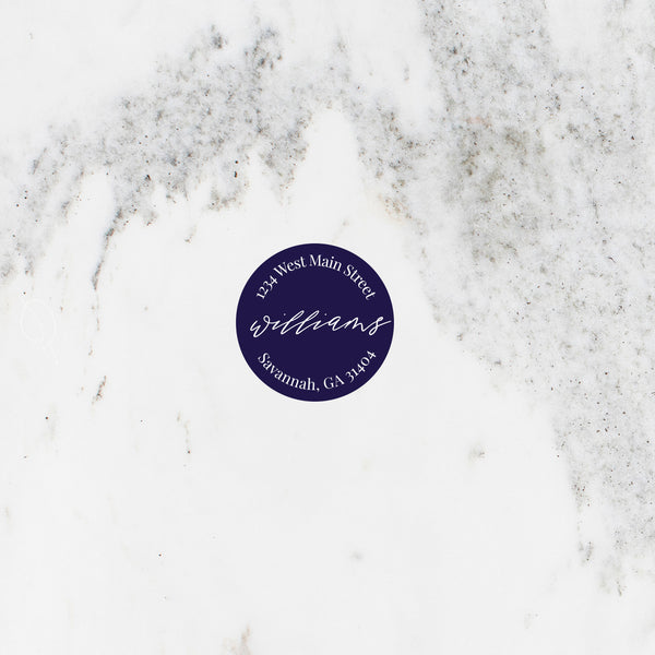 Circle address sticker in navy with modern script font.