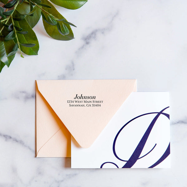 blush envelope with monogram card and classic serif return address