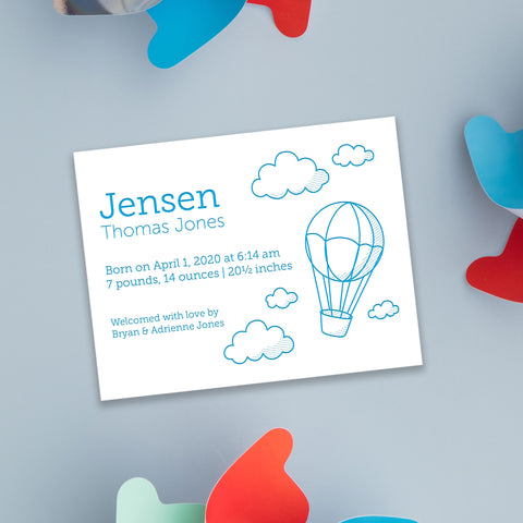 letterpress birth announcement with cloud and hot air balloon drawing in blue ink