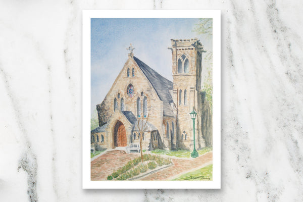 Watercolor postcard of University of Virginia University Chapel on white marble countertop.