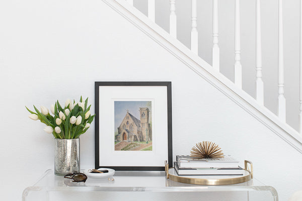 watercolor print of University of Virginia Chapel in black frame on entryway table