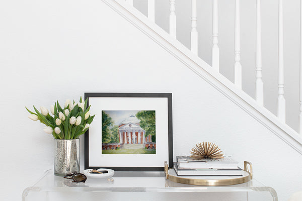 Watercolor print of University of Virginia Rotunda in black frame on entryway table