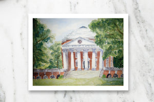 Watercolor postcard of University of Virginia Rotunda on white marble countertop.